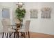 Bright dining room featuring a glass table, decorative tree art, and modern light fixture at 3925 Dunaire Dr, Valrico, FL 33596