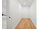 Hallway with wooden floor and a view to an elegant bathroom at 3925 Dunaire Dr, Valrico, FL 33596