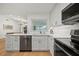 Bright kitchen with white cabinets, granite countertops, and stainless steel appliances at 3925 Dunaire Dr, Valrico, FL 33596
