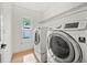 Bright laundry room with modern washer and dryer units and a window for fresh air at 3925 Dunaire Dr, Valrico, FL 33596