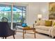 Living room with sofa, pillows, area rug, coffee table, view to pool and patio at 3925 Dunaire Dr, Valrico, FL 33596