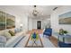 Living room with wood floors, white walls, blue chairs, sofa, coffee table, and decor at 3925 Dunaire Dr, Valrico, FL 33596