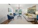 Living room with white walls, sofa, blue chairs, coffee table, area rug, and view to the pool at 3925 Dunaire Dr, Valrico, FL 33596