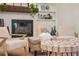 Living room showcasing a brick fireplace, comfortable seating, and decorative shelving at 3925 Dunaire Dr, Valrico, FL 33596