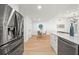 Contemporary open living space featuring stainless steel appliances, and an adjacent dining area at 3925 Dunaire Dr, Valrico, FL 33596