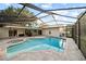 Screened-in pool and hot tub with brick pavers create a relaxing backyard oasis at 3925 Dunaire Dr, Valrico, FL 33596