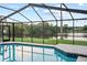 A view of the pool and lake from inside the screened-in patio at 3925 Dunaire Dr, Valrico, FL 33596