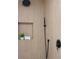 Modern shower featuring wood-look tile, sleek fixtures, and a built-in shelf at 3925 Dunaire Dr, Valrico, FL 33596