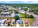 An aerial view showcasing houses near local shops and a blue community tennis court at 4307 Shadberry Dr, Tampa, FL 33624