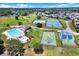Aerial view of community amenities with pool, tennis courts, playground, and green spaces at 4307 Shadberry Dr, Tampa, FL 33624