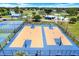 Overhead shot of new community basketball courts with new hoops surrounded by landscaping and tennis courts at 4307 Shadberry Dr, Tampa, FL 33624