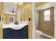 Bathroom with dark blue vanity and walk-in shower at 4307 Shadberry Dr, Tampa, FL 33624