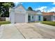 Charming single-story home with a well-manicured lawn, driveway, and attached garage at 4307 Shadberry Dr, Tampa, FL 33624