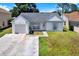 Charming single-story home featuring a well-manicured lawn, inviting entryway, and attached garage at 4307 Shadberry Dr, Tampa, FL 33624