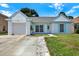 Charming single-story home featuring a well-manicured lawn, inviting entryway, and attached garage at 4307 Shadberry Dr, Tampa, FL 33624