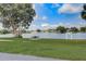 Picturesque lake view with walking path, picnic table and Sunset Point sign against a blue sky at 4307 Shadberry Dr, Tampa, FL 33624