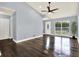 An empty living room featuring hardwood floors, high ceilings, and an abundance of natural light at 4307 Shadberry Dr, Tampa, FL 33624