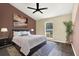 Comfortable primary bedroom featuring a large bed, neutral walls, ceiling fan, and a sunny window at 4307 Shadberry Dr, Tampa, FL 33624