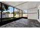 Enclosed patio featuring tiled flooring, screened windows, and built-in storage cabinets at 4307 Shadberry Dr, Tampa, FL 33624