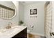 Clean bathroom with a modern sink, vanity, mirror, and shower with a checkered shower curtain at 4419 Longshore Dr, Land O Lakes, FL 34639