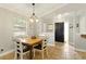 Bright dining area featuring natural light, a pendant light fixture and easy access to the entrance at 4419 Longshore Dr, Land O Lakes, FL 34639