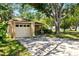 Charming single-story home with a large tree providing shade over the driveway and front yard at 4419 Longshore Dr, Land O Lakes, FL 34639