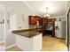 Spacious kitchen with stone floors, modern appliances, and beautiful cabinetry, perfect for cooking and entertaining at 4419 Longshore Dr, Land O Lakes, FL 34639