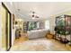 Well-lit living room showcasing stone tile floors, a comfortable gray sofa, and an adjacent outdoor space at 4419 Longshore Dr, Land O Lakes, FL 34639