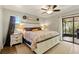 Spacious main bedroom with a sliding door to the outside screened-in patio at 4419 Longshore Dr, Land O Lakes, FL 34639