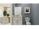 Modern half-bathroom with grey walls, white vanity, and elegant decor at 4511 S Manhattan Ave # 3, Tampa, FL 33611