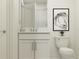A minimalist bathroom features a modern vanity, sleek hardware, a marble countertop and tiled shower at 4511 S Manhattan Ave # 3, Tampa, FL 33611
