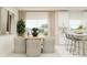 Bright dining area featuring a round table with cushioned chairs and white kitchen cabinets in the background at 4511 S Manhattan Ave # 3, Tampa, FL 33611