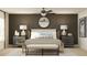 Serene main bedroom featuring neutral tones, decorative lamps, a ceiling fan, and stylish furnishings at 4511 S Manhattan Ave # 3, Tampa, FL 33611