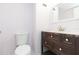 Bathroom features a dark wood vanity and toilet at 4517 La Capri Ct, Tampa, FL 33611