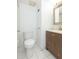 This bathroom includes a toilet, vanity, mirror and shower with white walls and tile floors at 4517 La Capri Ct, Tampa, FL 33611