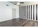 This bedroom features dark wood floors and a bold black and white striped accent wall at 4517 La Capri Ct, Tampa, FL 33611