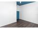 A bedroom featuring dark wood floors, a blue painted ceiling and a blue painted door at 4517 La Capri Ct, Tampa, FL 33611