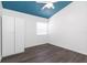 A bedroom featuring dark wood floors, a white ceiling fan and a large window at 4517 La Capri Ct, Tampa, FL 33611