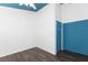 A bedroom featuring dark wood floors, a ceiling fan and blue painted ceiling at 4517 La Capri Ct, Tampa, FL 33611