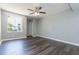 This spacious bedroom features dark wood floors, a ceiling fan and natural light from a large window at 4517 La Capri Ct, Tampa, FL 33611