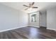 Bedroom features a ceiling fan, window, door and wood-look floors at 4517 La Capri Ct, Tampa, FL 33611