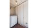 Shed interior featuring a washing machine, wood-look floors, and a light overhead at 4517 La Capri Ct, Tampa, FL 33611
