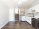 Open kitchen with stainless steel appliances, dark wood floors, and stairs at 4517 La Capri Ct, Tampa, FL 33611
