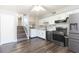 Kitchen featuring stainless steel appliances, dark wood floors, and adjacent staircase at 4517 La Capri Ct, Tampa, FL 33611