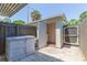 Open exterior shed in backyard featuring a white door and an open entrance at 4517 La Capri Ct, Tampa, FL 33611