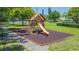 Colorful playground area with a slide, swings and monkey bars and tennis court at 4517 La Capri Ct, Tampa, FL 33611