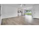 Bright, empty living room featuring wood-look floors, fresh paint and access to the backyard at 4650 32Nd N Ave, St Petersburg, FL 33713