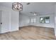 Bright, empty living room featuring wood-look floors, fresh paint, and double front doors at 4650 32Nd N Ave, St Petersburg, FL 33713