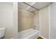This bathroom features a tiled shower, a white tub, and a toilet at 4804 N 18Th St, Tampa, FL 33610