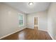 A modest bedroom is well-lit by natural light and features vinyl hardwood floors at 4804 N 18Th St, Tampa, FL 33610
